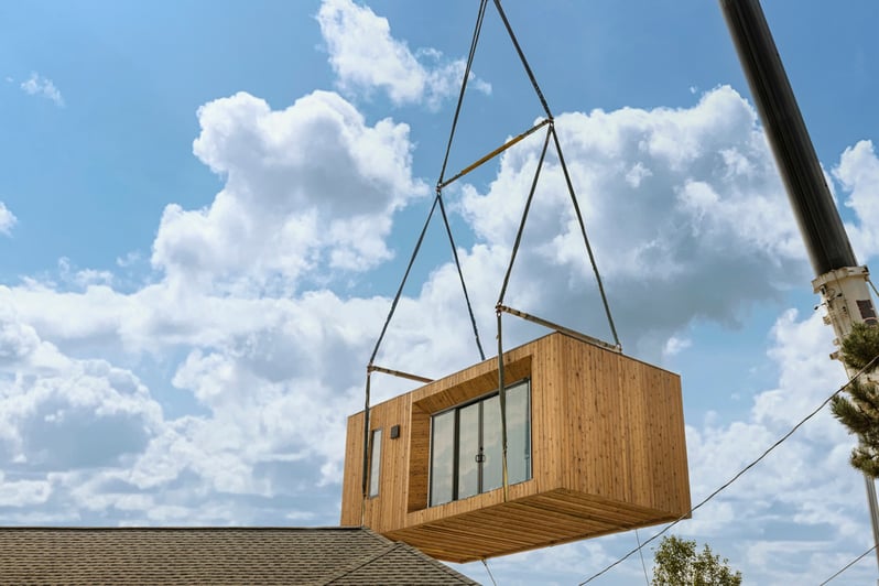 Modal 00 being craned over a home for installation 