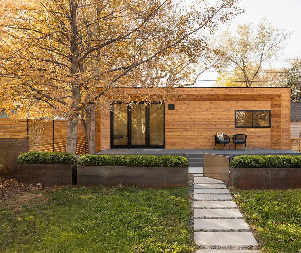 A Modal ADU with a walkway and trees in the fall 