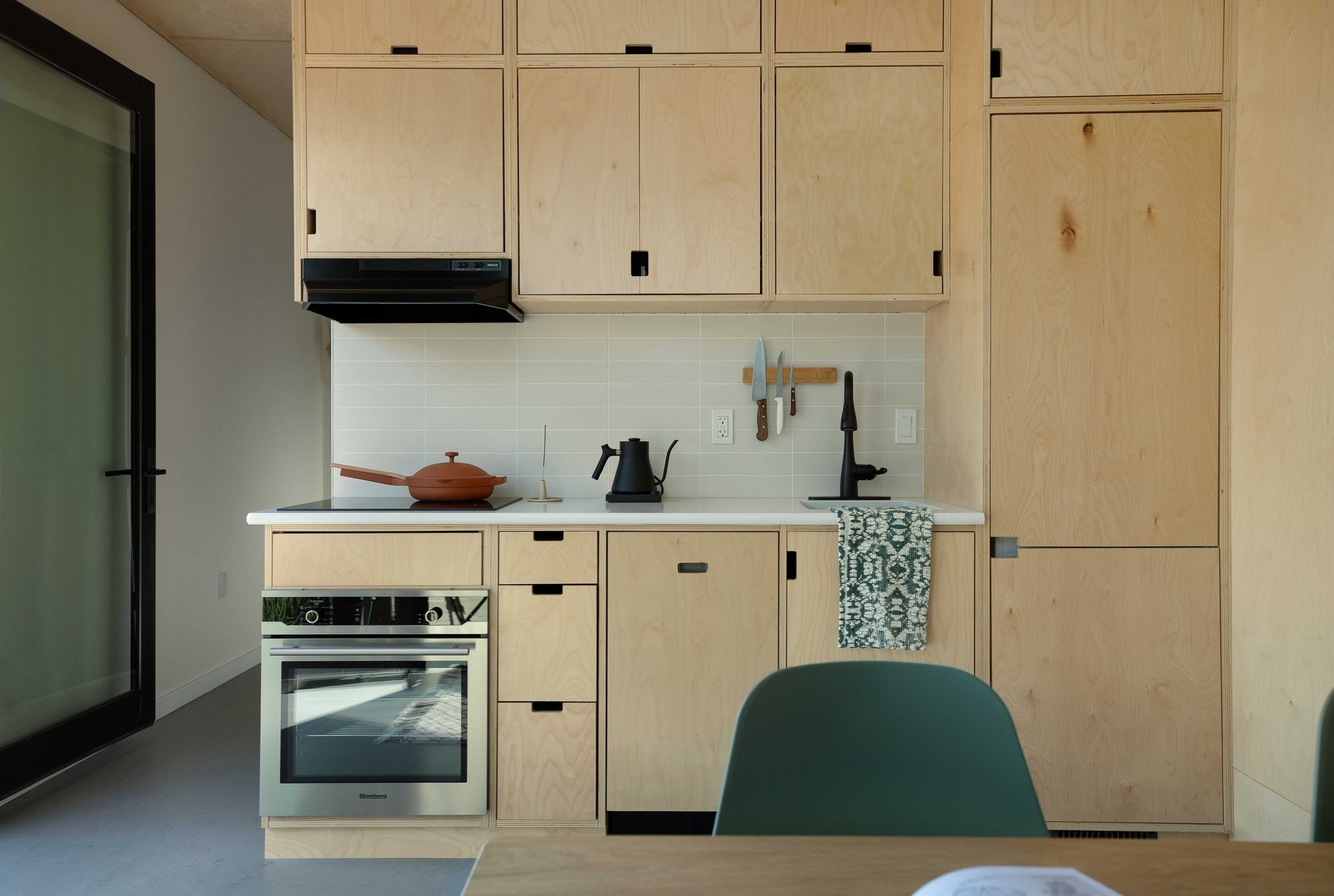  The interior of a Modal ADU, with a kitchen and table.