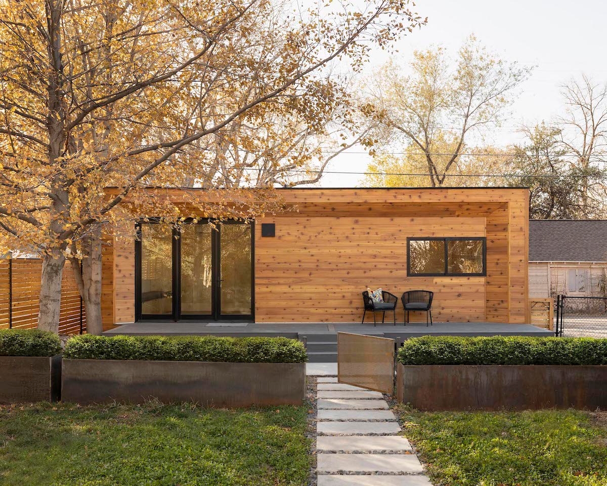 Modal 01 unit with light wooden paneling in a backyard on an autumn day